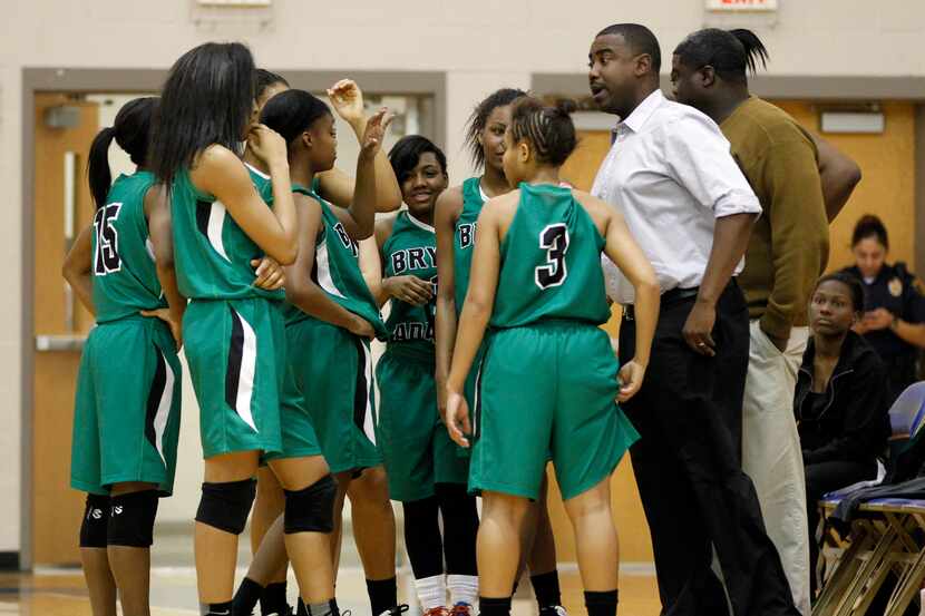 Bryan Adams head coach Darren Eubanks, right, talks to his team during a time out in the...