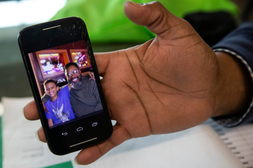 Randy Thornton holds up a photograph of him and his now 11-year-old son Jackson Emmanuel...