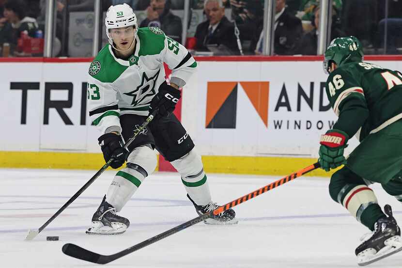 Dallas Stars center Wyatt Johnston (53) handles the puck in front of Minnesota Wild...