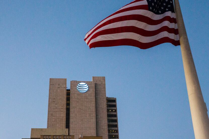 The AT&T headquarters building with the American flag that flies in front of city hall on...