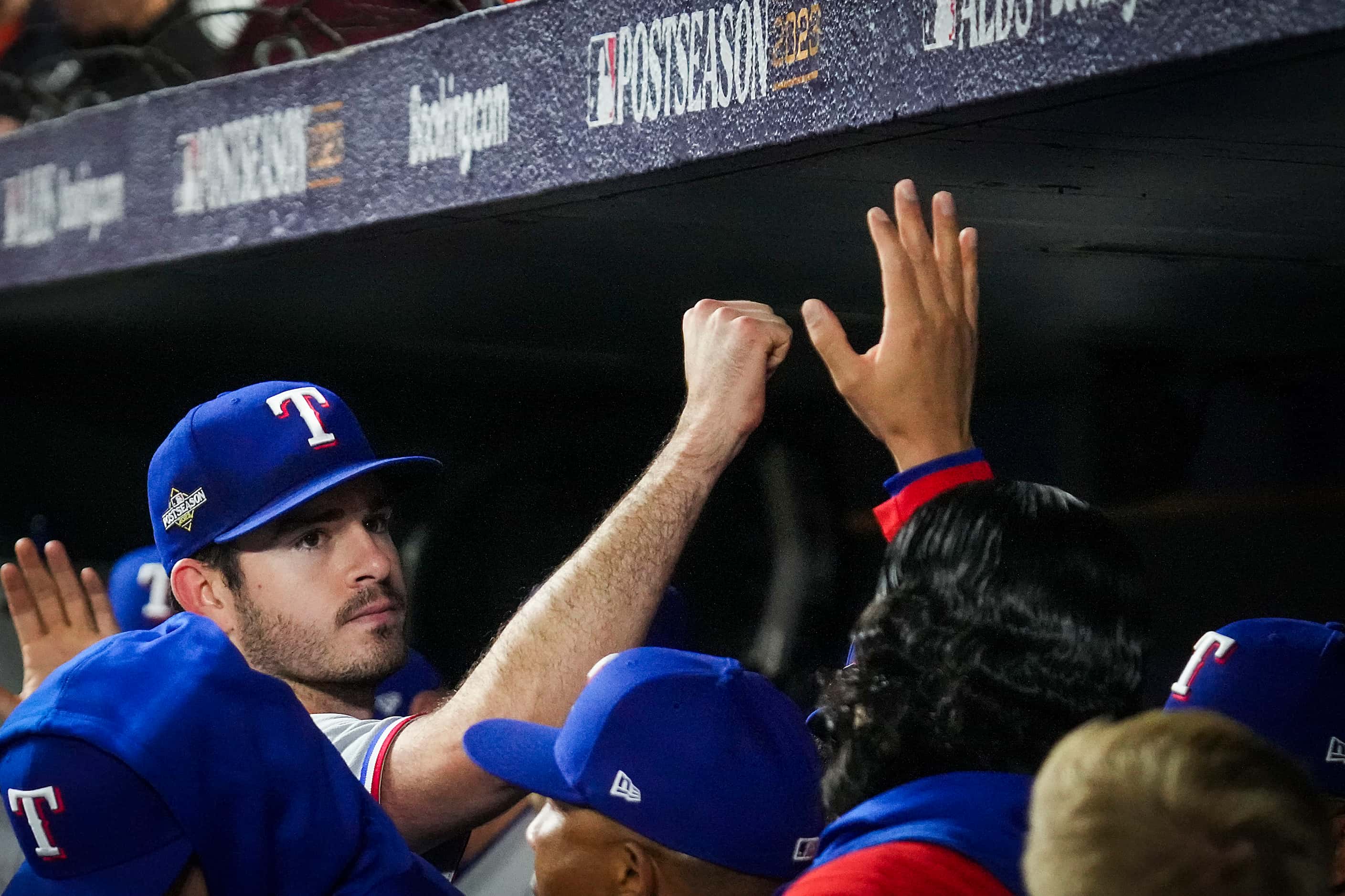 Texas Rangers pitcher Cody Bradford gets a hand in the dugout as he leaves the game during...