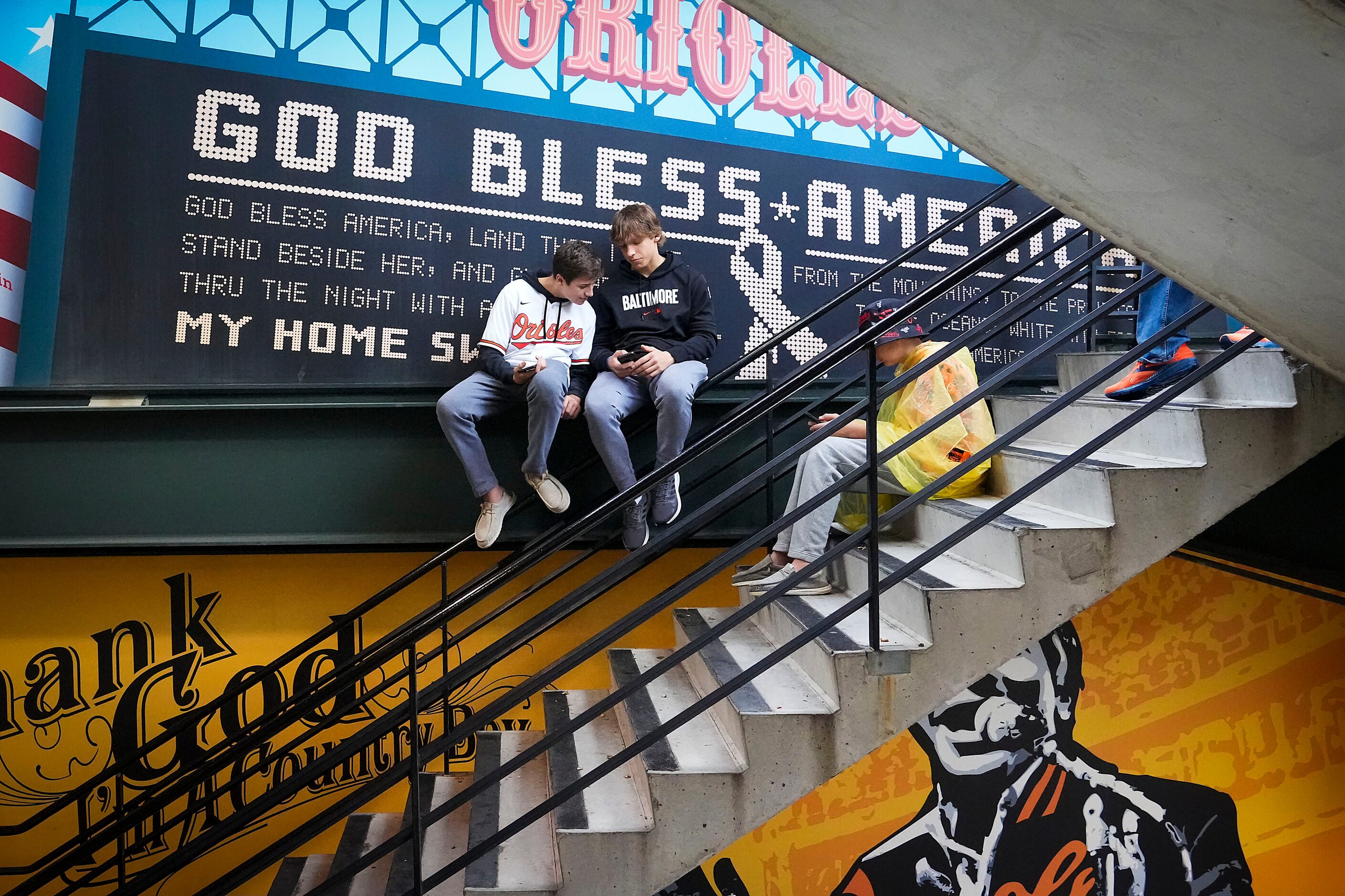 Fans sit in stairwells during a rain delay prior to Game 1 of an American League Divisional...