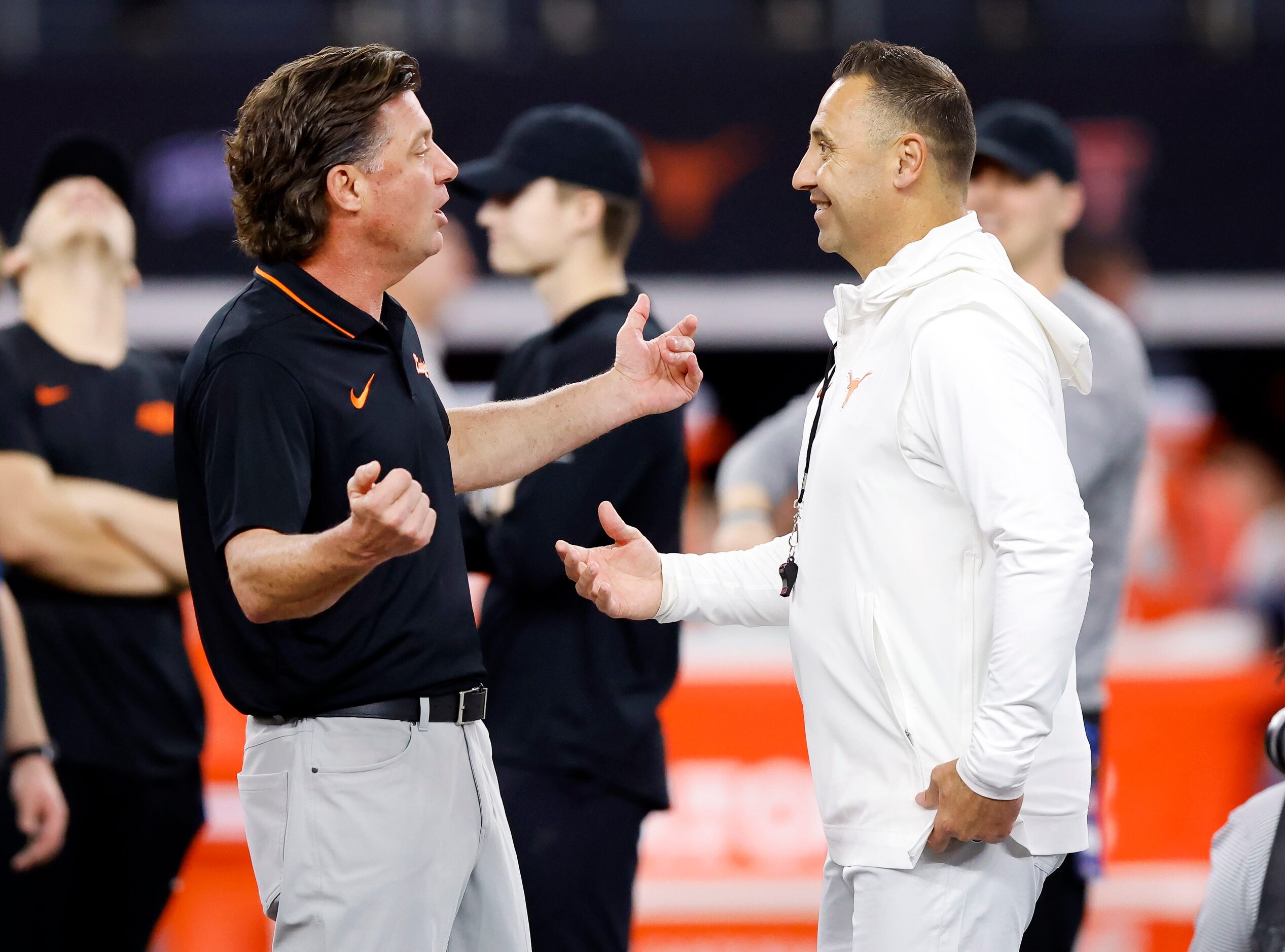 Oklahoma State Cowboys head coach Mike Gundy (left) and Texas Longhorns head coach Steve...