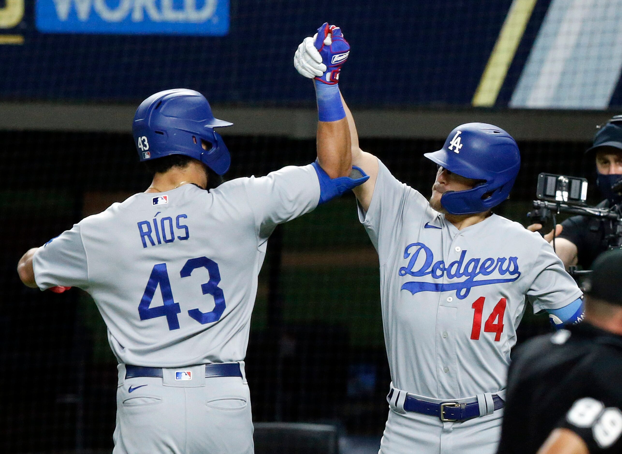 Los Angeles Dodgers Edwin Rios (43) is congratulated by his teammate Enrique Hernandez (14)...