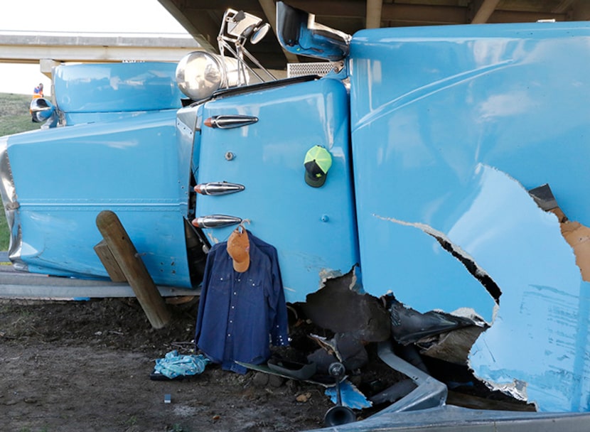  Shirts and a hat hang on the roof of the overturned 18-wheeler. (David Woo/The Dallas...