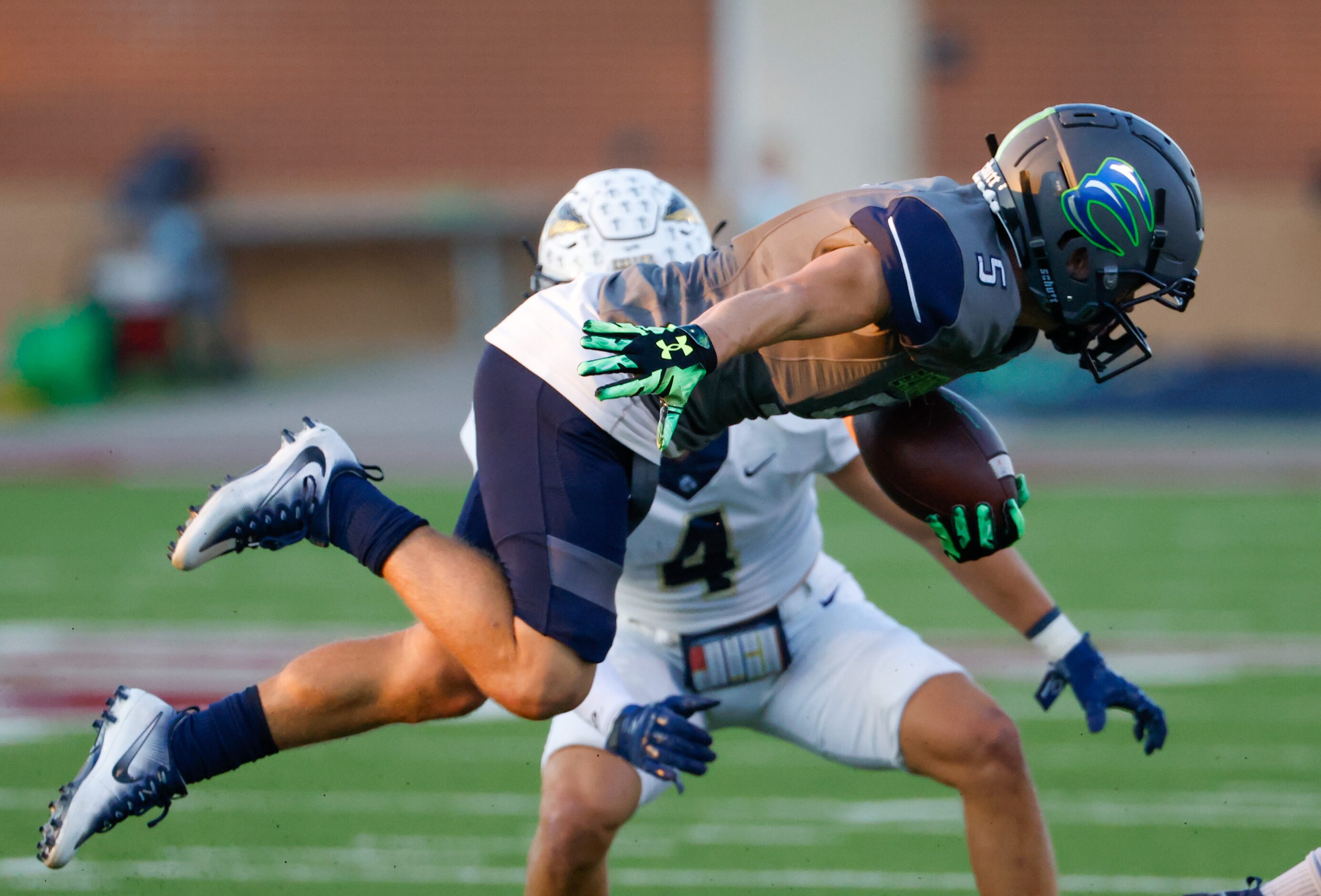 V.R. Eaton High School wide receiver Mason Stubbe (5) launches himself forward as he’s...