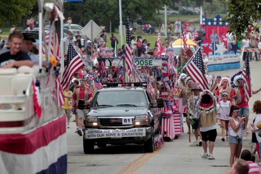 Arlington's annual Independence Day Parade makes its way north on West Street in this file...
