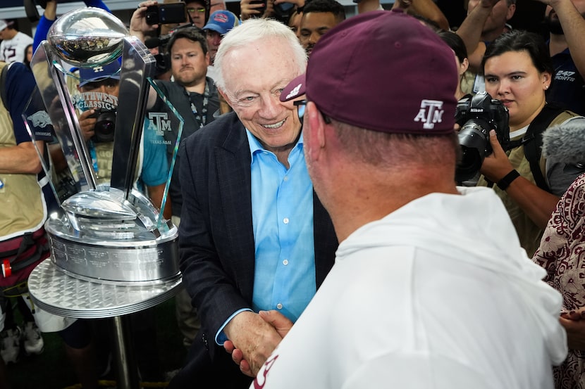 Dallas Cowboys owner and general manager Jerry Jones congratulates Texas A&M head coach Mike...