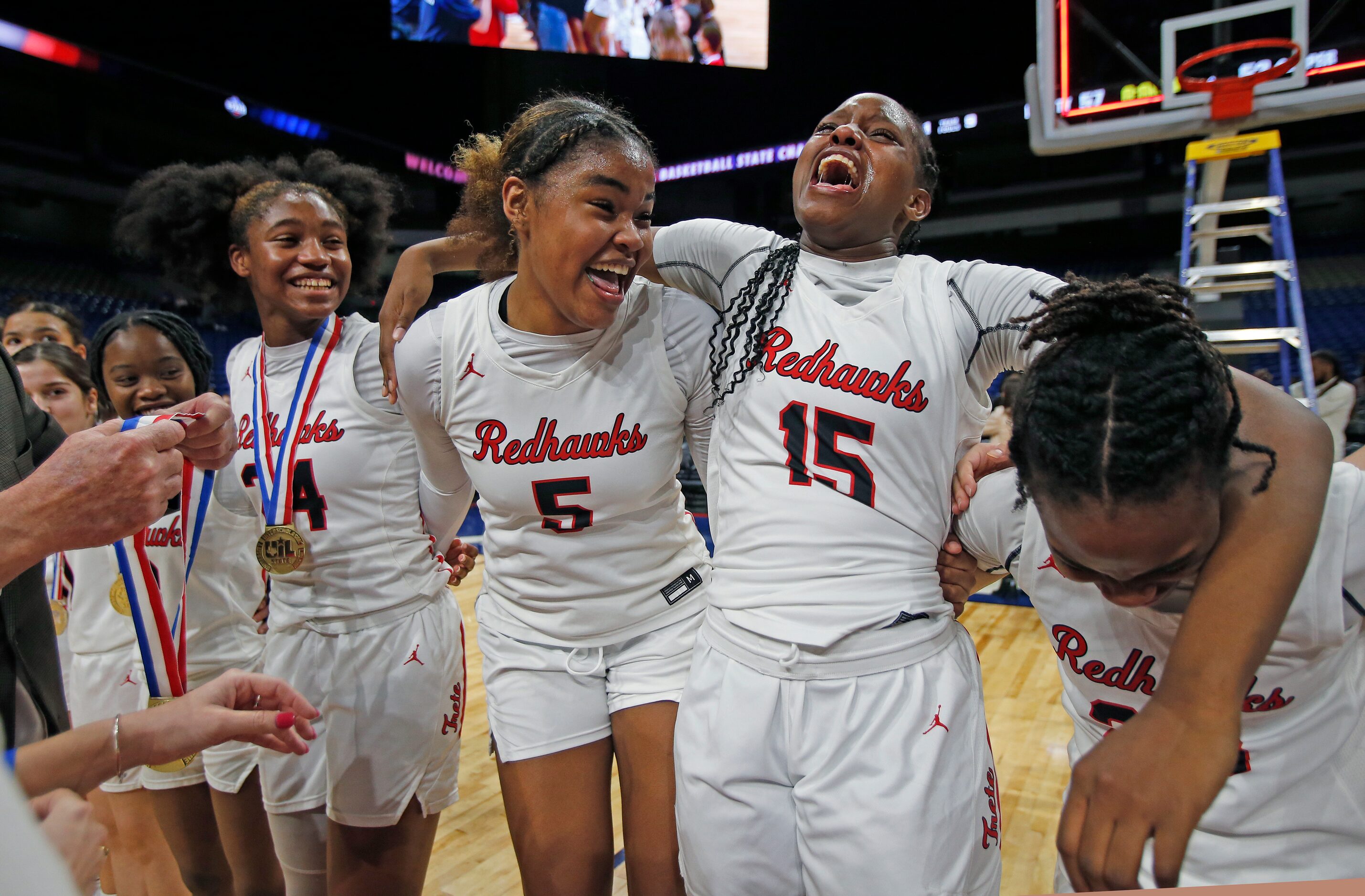 Frisco Liberty Keyera Roseby (5) celebrates with Frisco Liberty Za’Naiha Hensley (15) and...