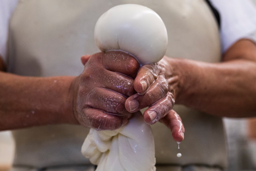 Cheese maker Carmen Lopez forms a ball of mozzarella at the Mozzarella Company in 2021.