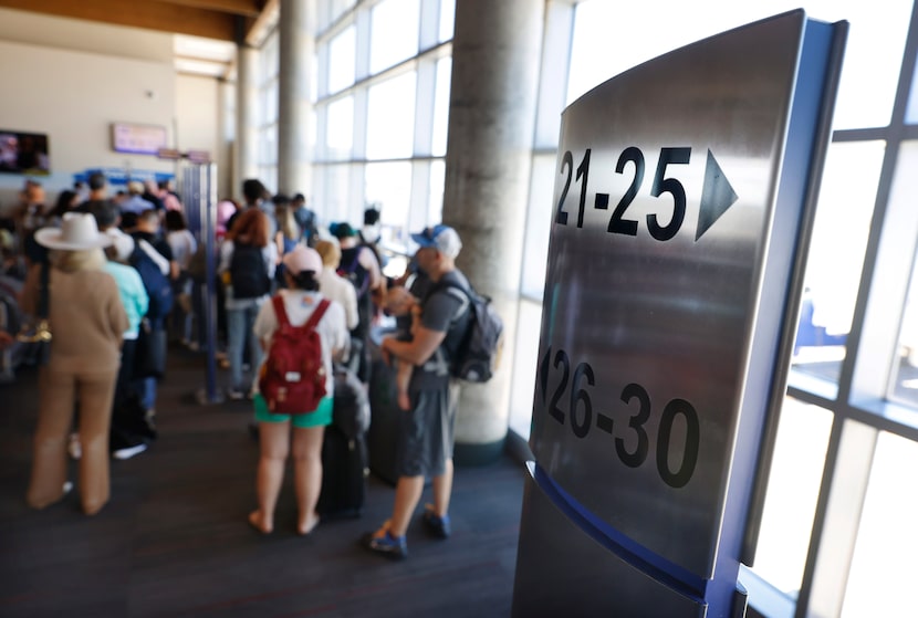 Southwest Airlines passengers wait in a queue to board for Minneapolis/St. Paul from Dallas...