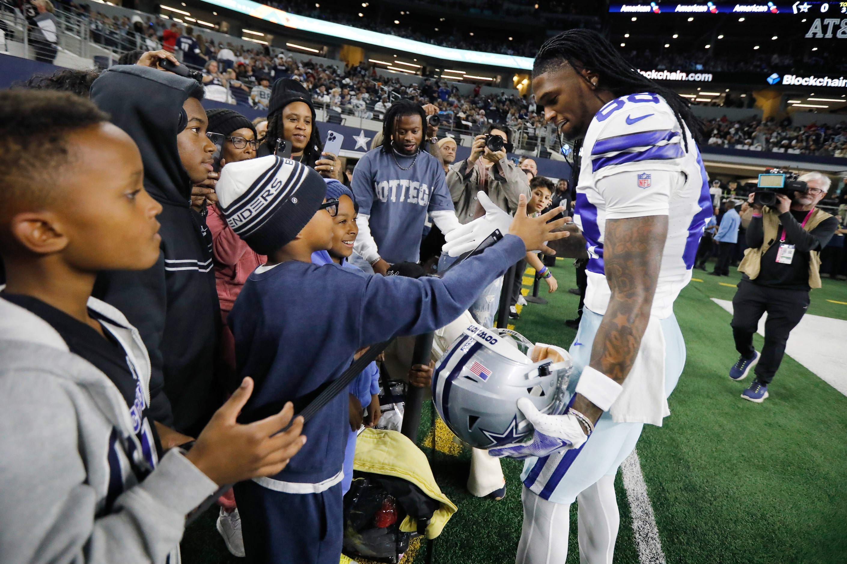 Dallas Cowboys wide receiver CeeDee Lamb (88) meets young fans on the sideline during...