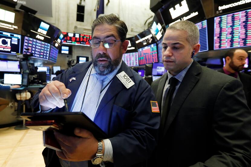Director of trading floor Ooperations Fernando Munoz, right, works with trader Robert Oswald...