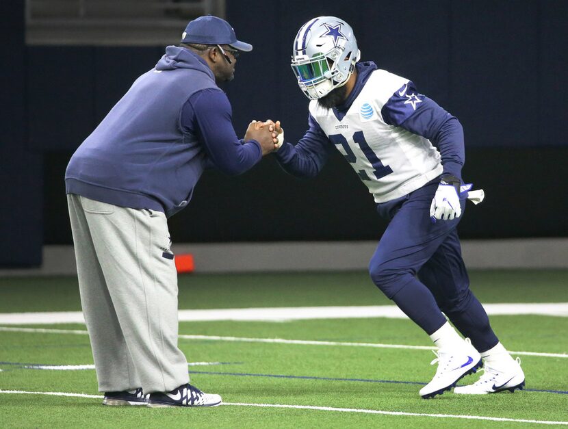 Dallas Cowboys running back Ezekiel Elliott (21) works with running backs coach Gary Brown...