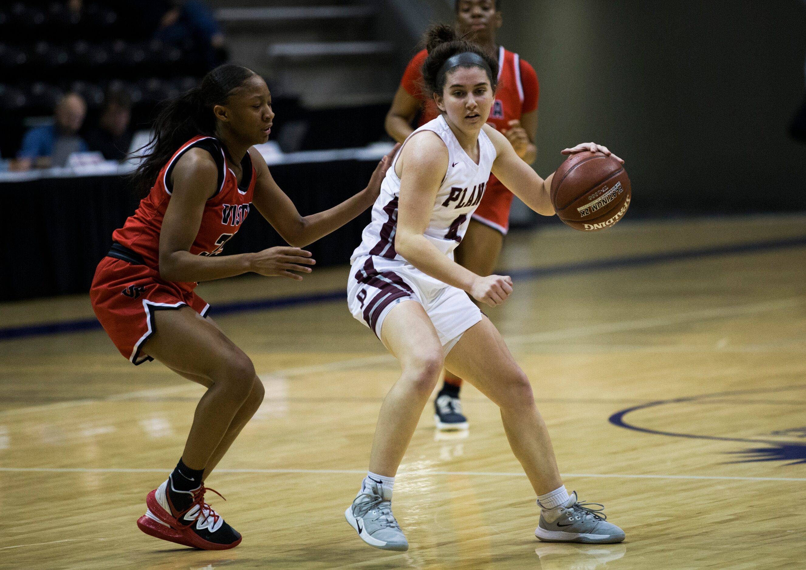 Plano guard Maggie Robbins (4) gets around Cedar Park Vista Ridge forward Nevaeh McNeil (35)...