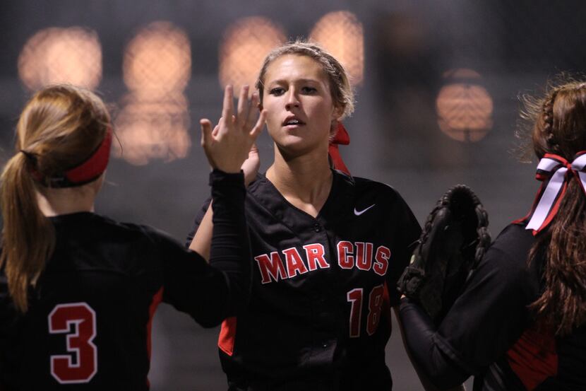 Flower Mound Marcus pitcher Hannah Null (18) receives congratulations from teammates after...