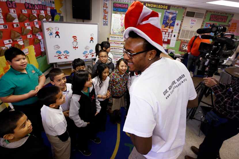 After reading two Dr. Seuss' books to students at Edward Titche Elementary School, Dallas...