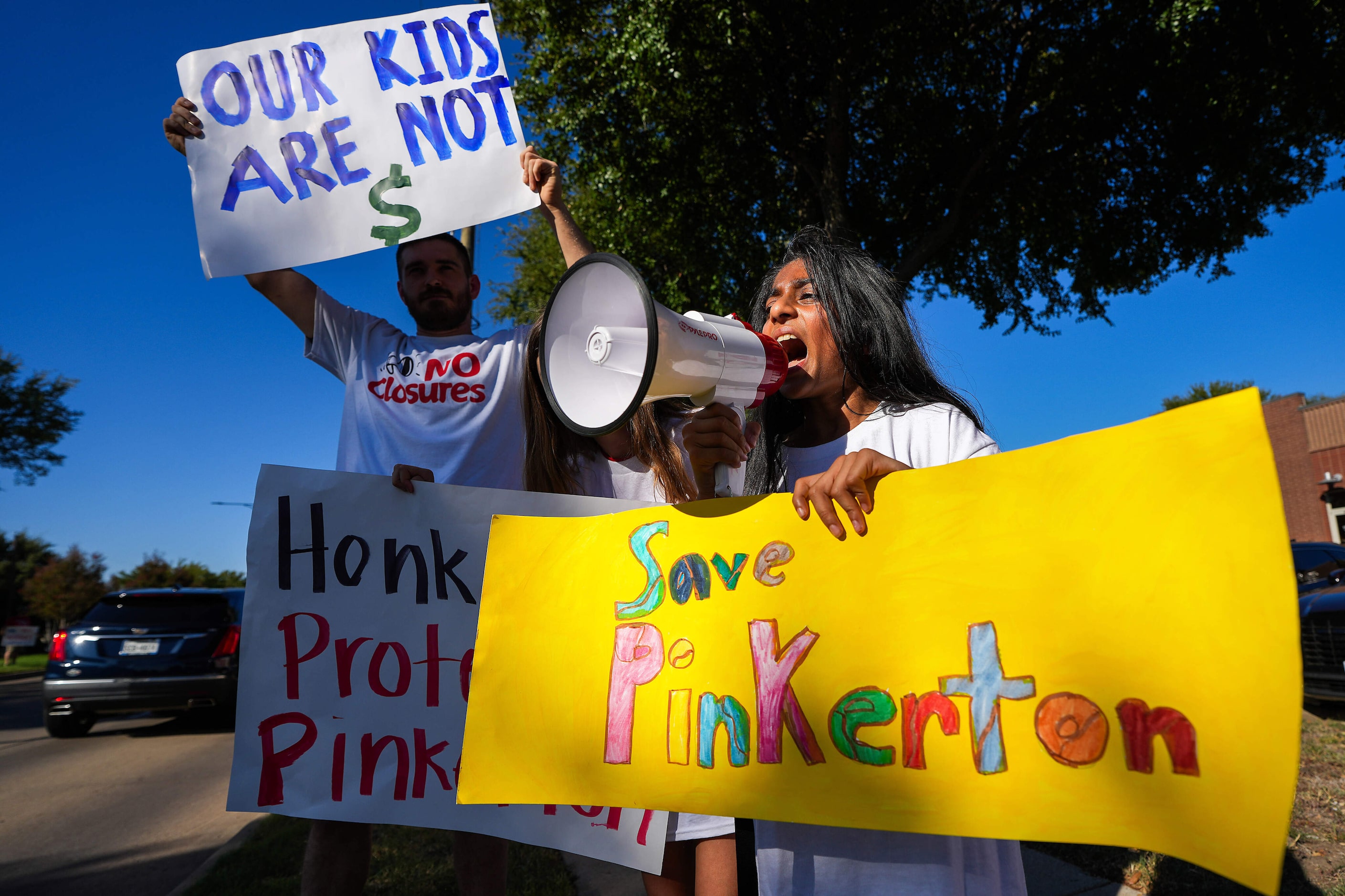 Pinkerton Elementary School fifth grader Niah Patel yells into a bullhorn as families...