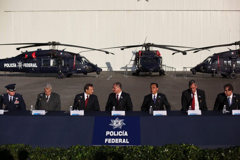 Mexico's Secretary of Public Safety Genaro Garcia Lunan (center) spoke with U.S. Ambassador...