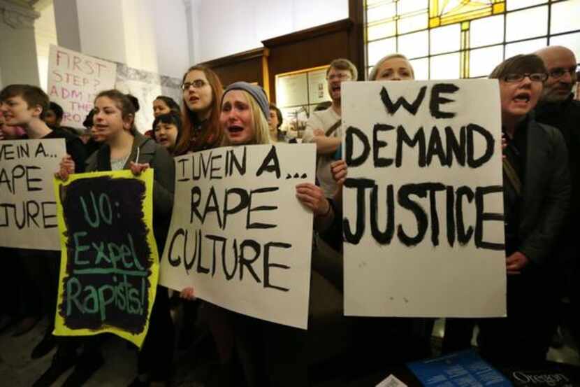 
University of Oregon student Samantha Cohen, center, joins a hundred fellow protesters on...