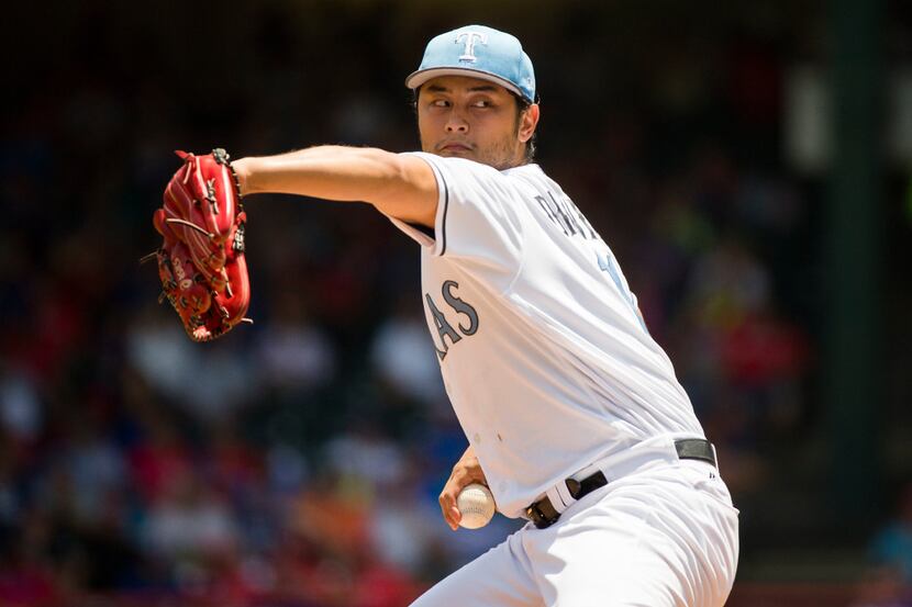 Texas Rangers starting pitcher Yu Darvish delivers a pitch during the first inning against...