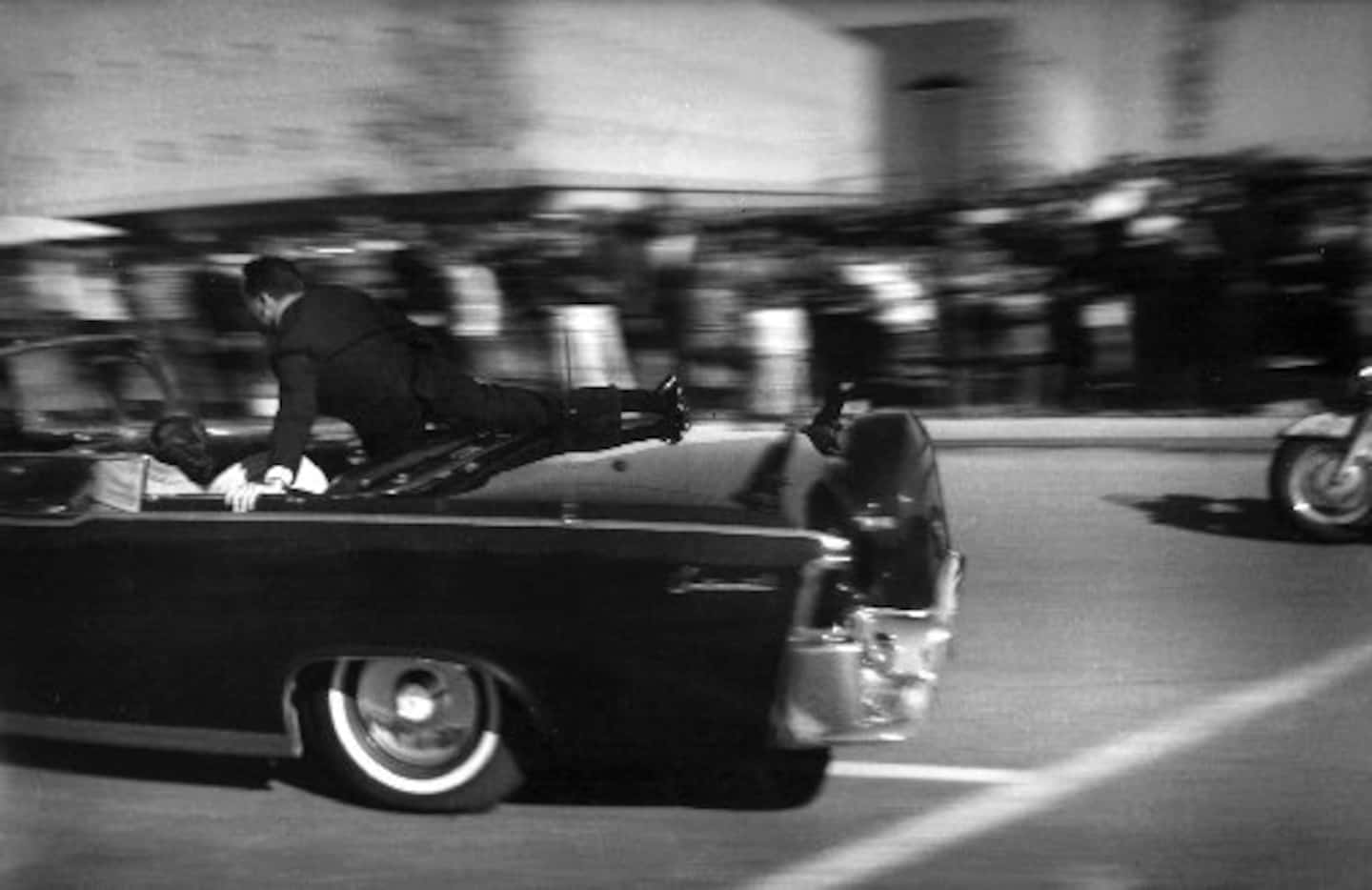 Pres. John F. Kennedy's limo speeds toward Parkland Hospital moments after he was shot in...