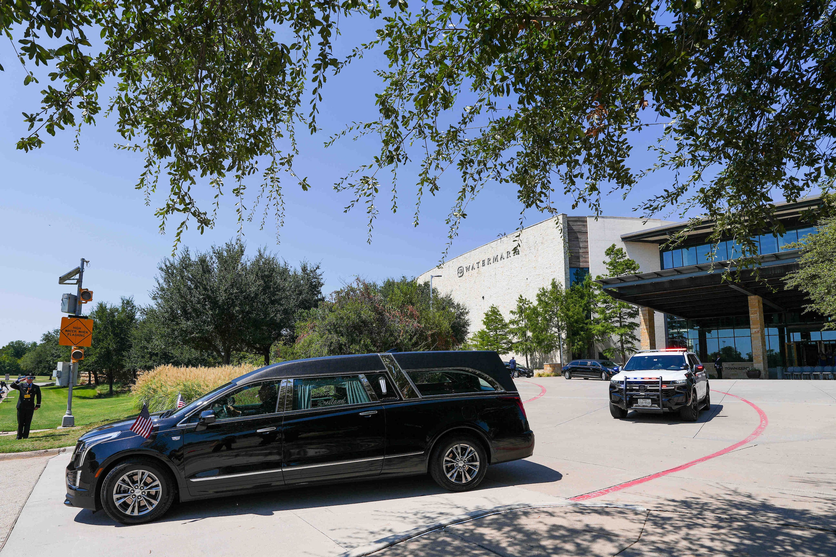 The hearse carrying the casket Dallas police officer Darron Burks departs Watermark...