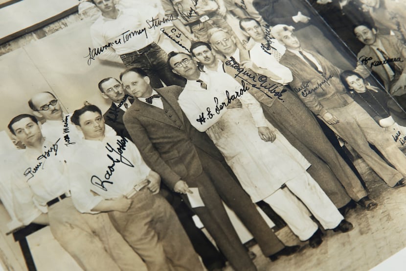 George L. Dahl (center in bowtie) poses with the men and women who helped design and...