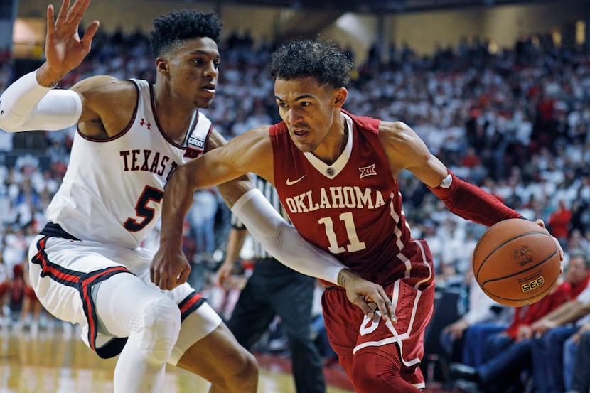 Oklahoma's Trae Young (11) dribbles the ball around Texas Tech's Justin Gray (5) during an...