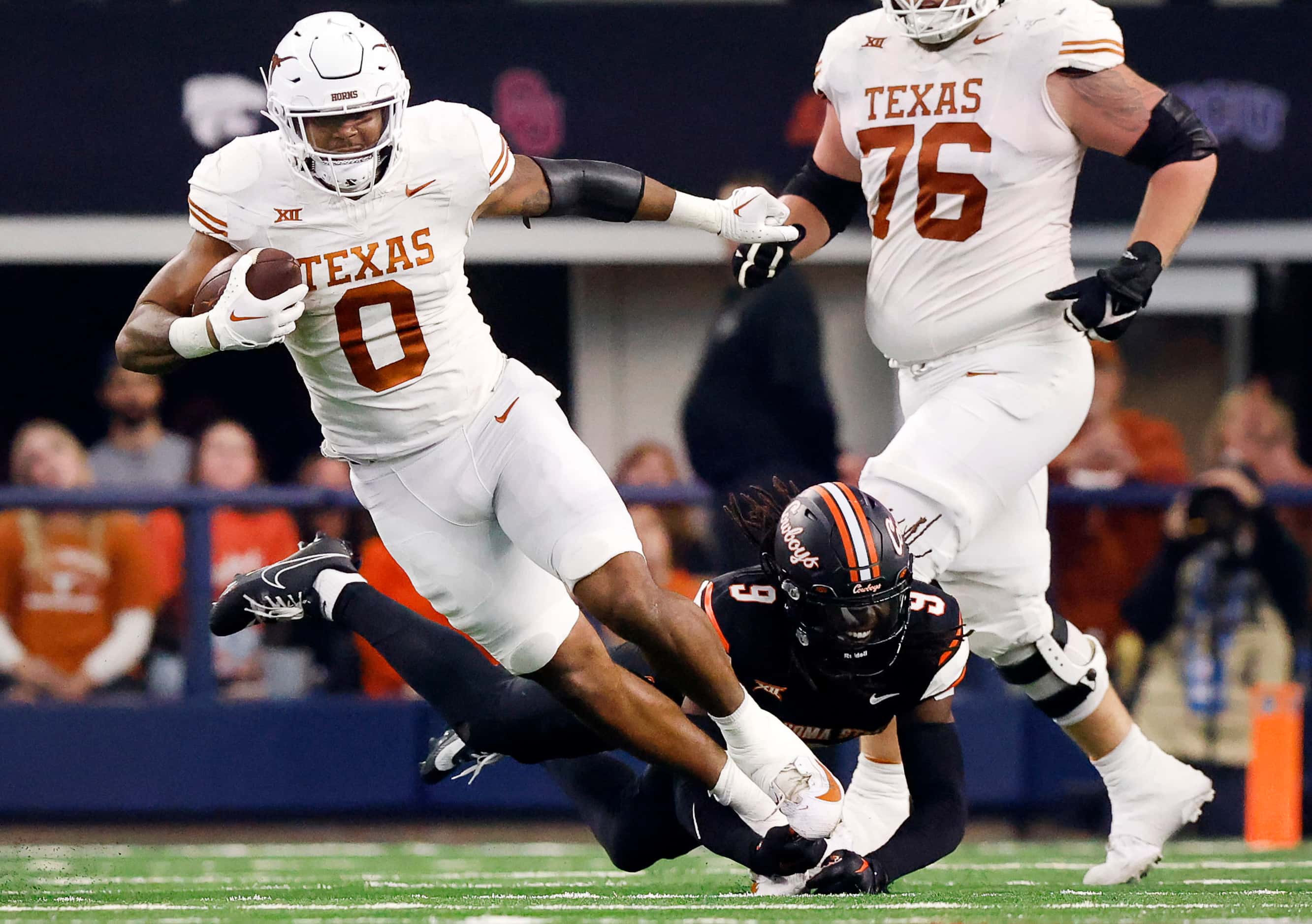 Texas Longhorns tight end Ja'Tavion Sanders (0) is tripped up from behind by Oklahoma State...