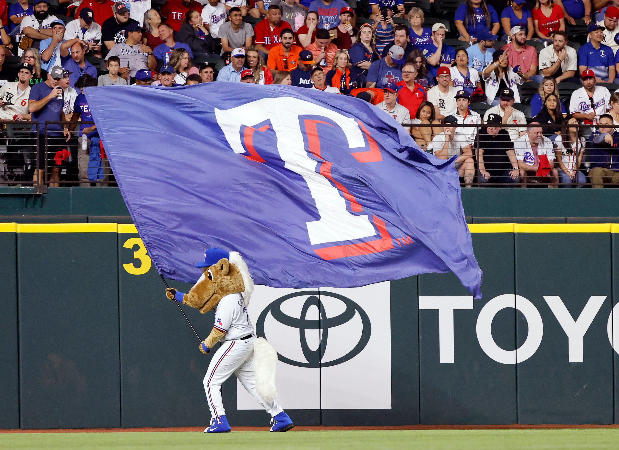 Texas Rangers mascot Captain waves the team flag during the sixth inning dot race in Game 4...