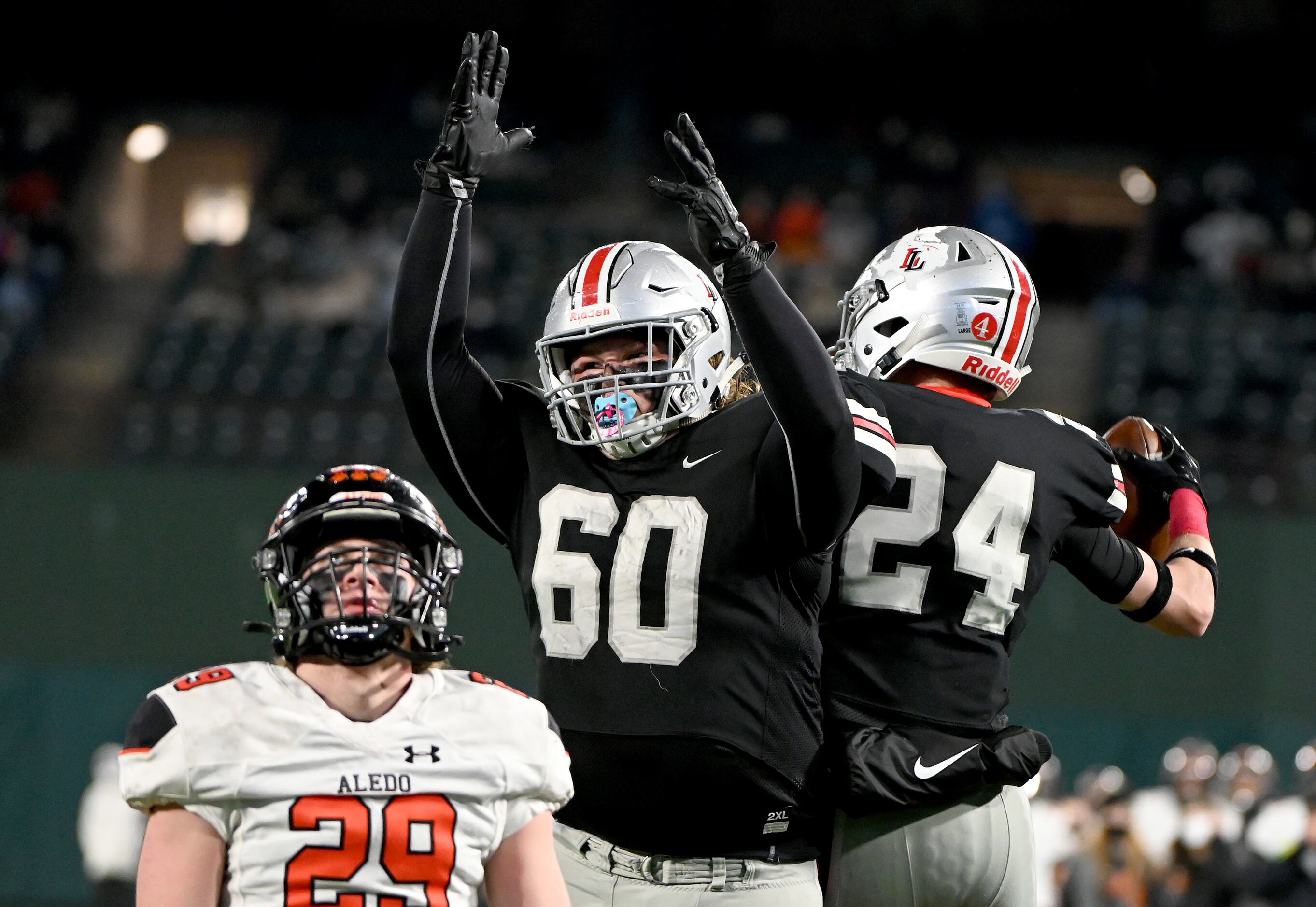 Lovejouy’s Trent Robinson (60) celebrates with Trent Rucker (24) after Rucker’s touchdown...