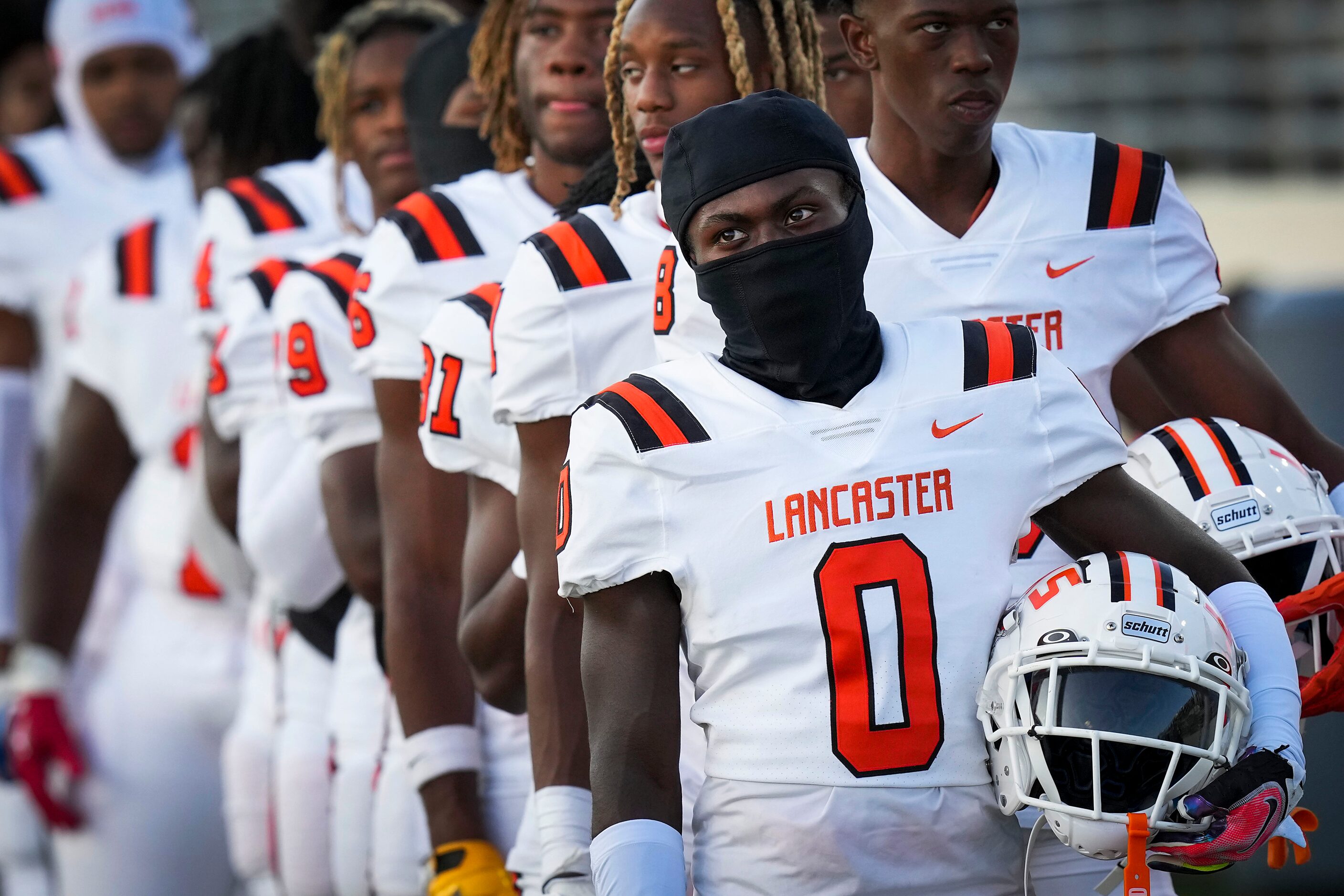 Lancaster wide receiver Ti'Erick Martin (0) stands for the national anthem before a high...