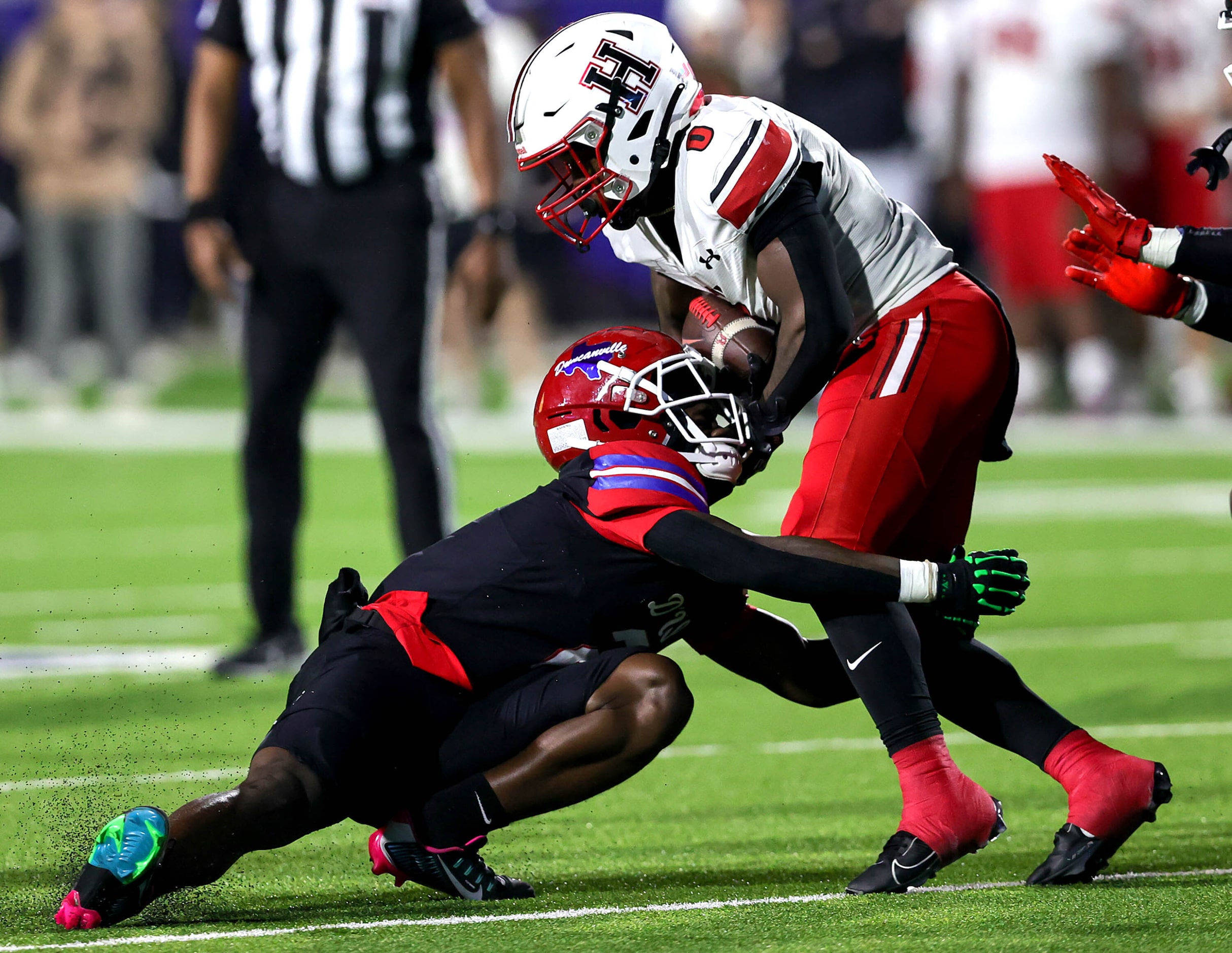 Rockwall Heath running Malachi Tuesno (0) tries to run over Duncanville defensive back...