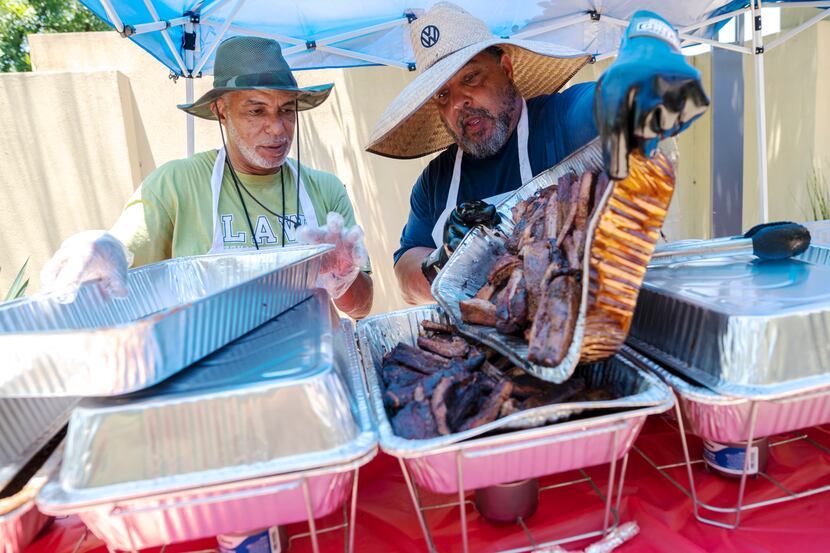 Co-owners Ernest Moore (left) and Ron Evans of Breaux BBQ dished up smoked meats during...