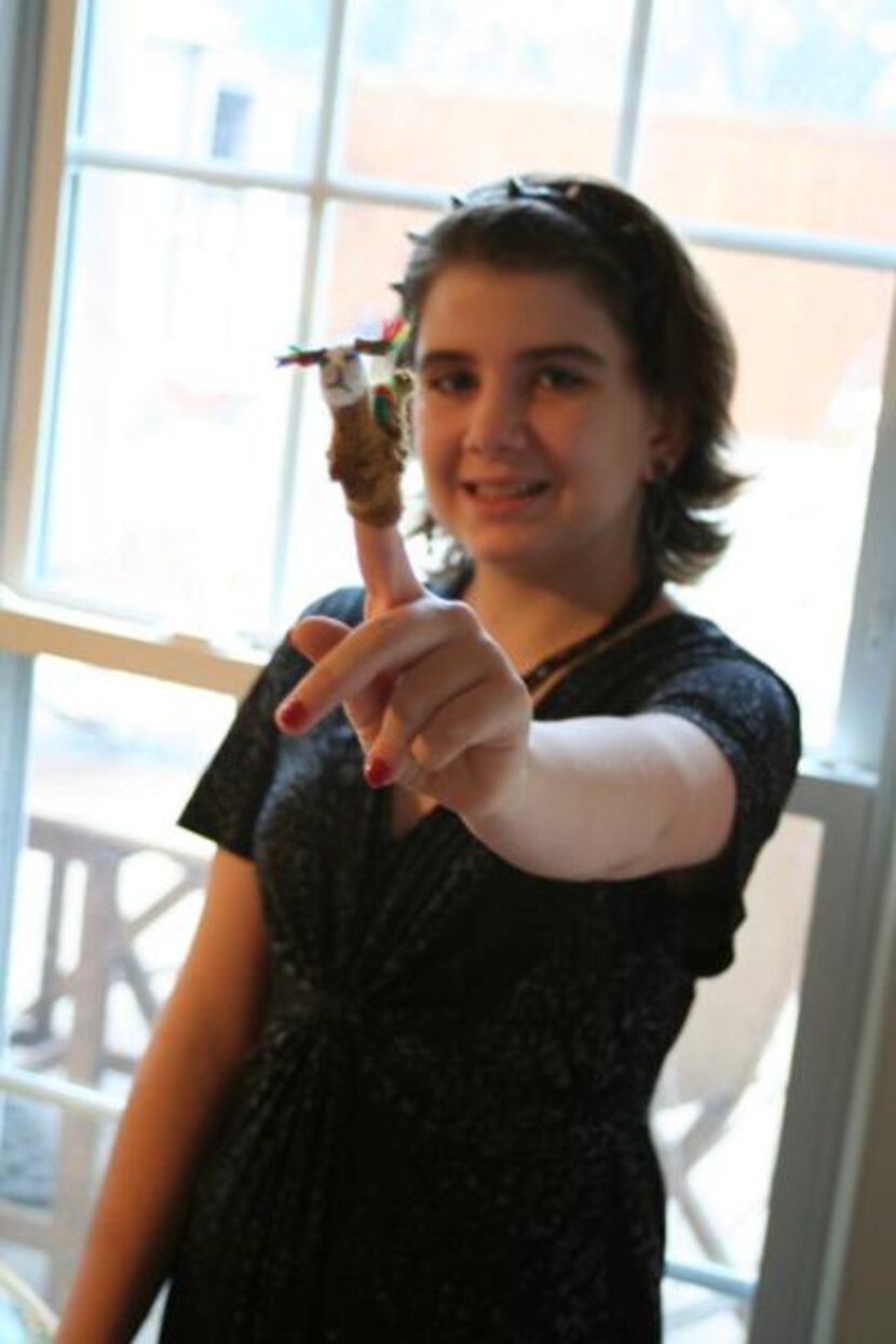 
Isabella displays a souvenir of the family’s time serving in Peru: a lama finger puppet.
