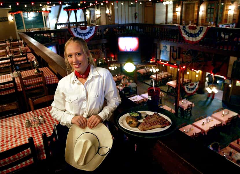 Waitress Sarah Beringer displayed the Cowboy, a 20-ounce steak, at the Trail Dust Steak...