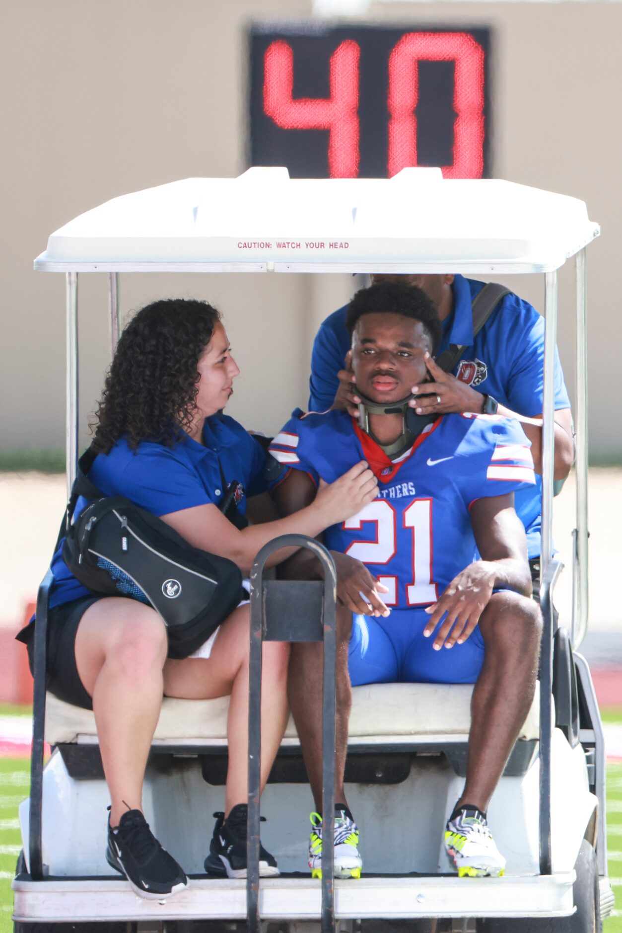 Duncanville High School Tyren Polley (21) gets hauled off the field wearing a neck brace...