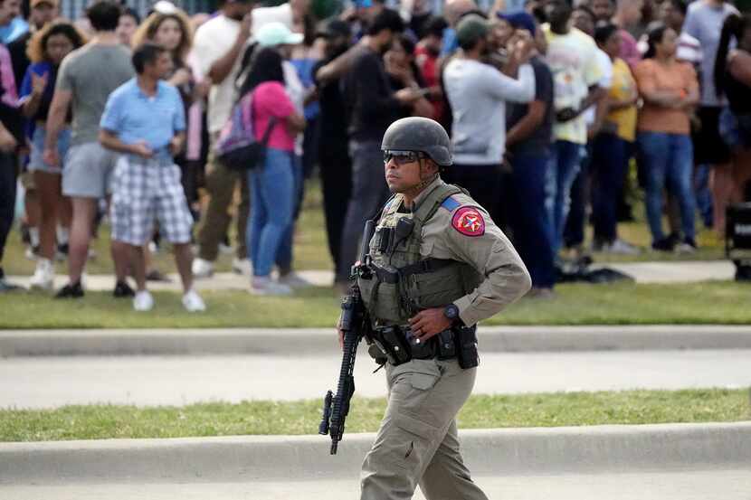 A Texas state trooper outside of a shopping mall after a mass shooting took the lives of...
