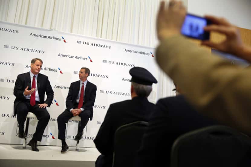US Airways CEO Doug Parker (left) and American Airlines CEO Tom Horton answer questions...