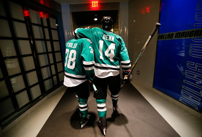 Dallas Stars left wing Jamie Benn (14) puts his arm around  teammate Vernon Fiddler (38) as...