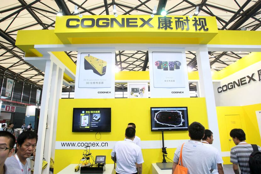 People visited the stand of American machine vision systems supplier Cognex during the 2014...