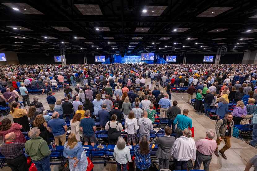 Attendees stood for worship during a Southern Baptist Convention annual meeting Tuesday,...