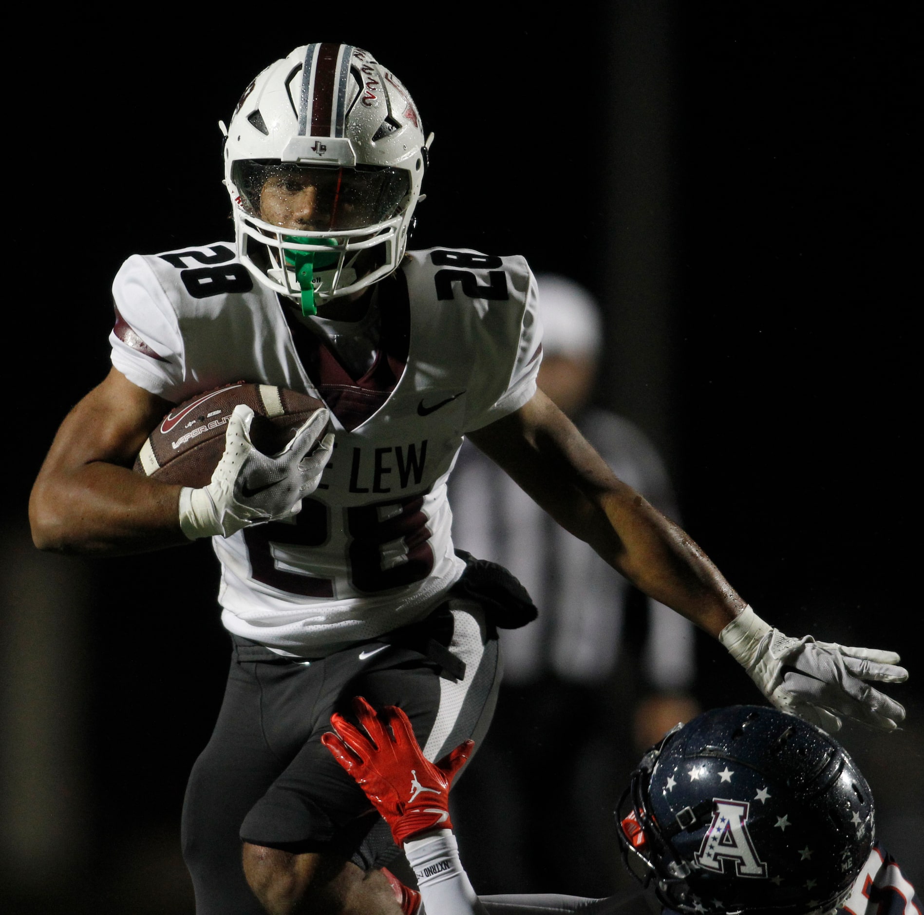 Lewisville running back Tenel Hill (28), eludes an Allen defender enroute to a 20-yard...