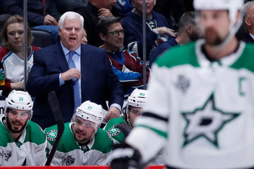 Dallas Stars head coach Ken Hitchcock, back, directs his team against the Colorado Avalanche...
