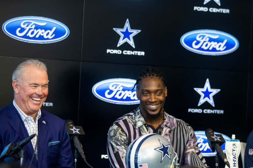 Dallas Cowboys CEO Stephen Jones, left, laughs along with defensive end Demarcus Lawrence...