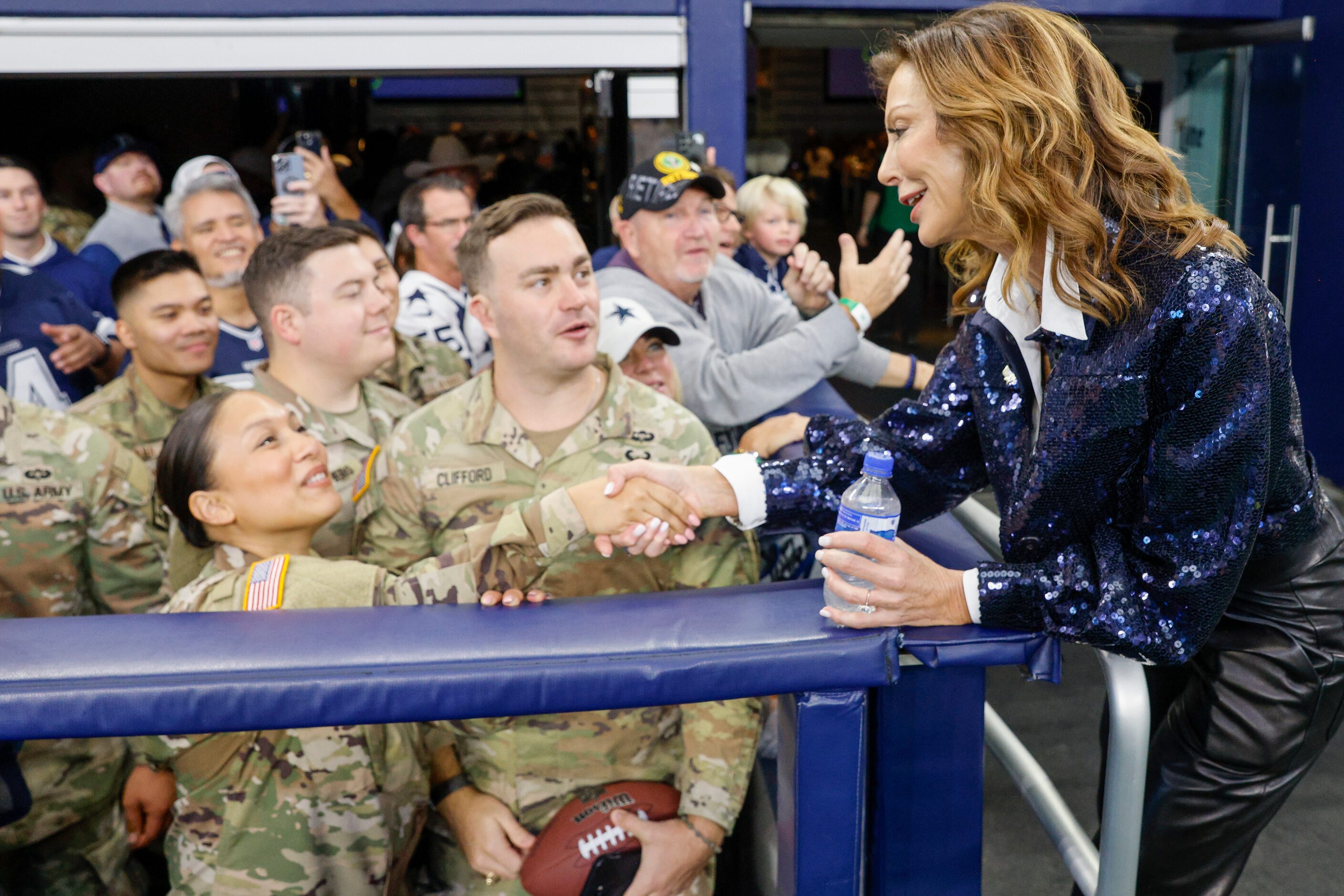 Executive Vice President and Chief Brand Officer Charlotte Jones (right) shakes hands with...