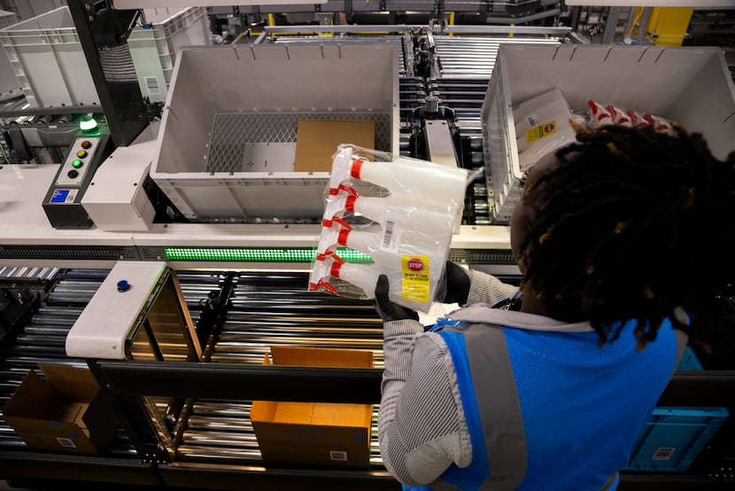 A worker picks an order inside of Walmart’s 1.5-million-square foot online fulfillment...