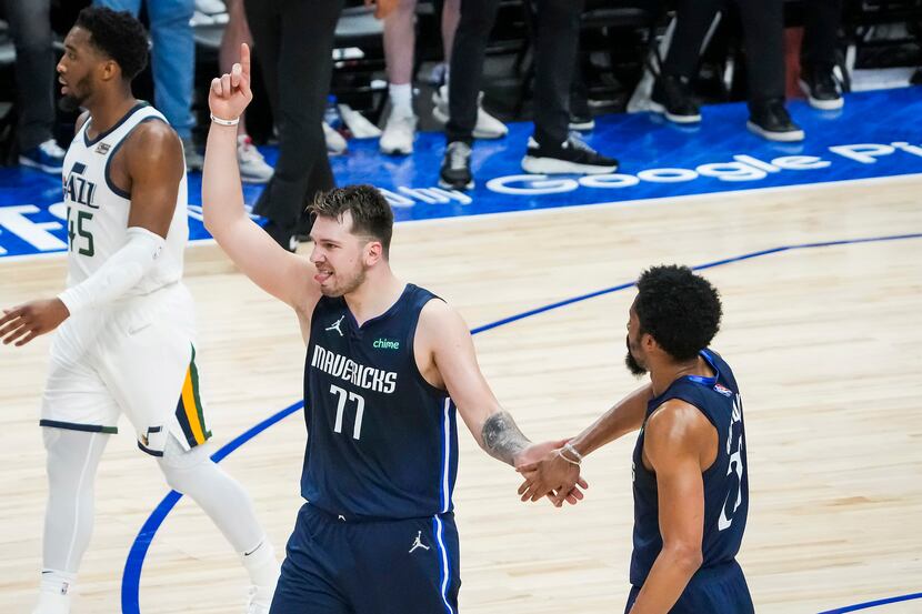 Dallas Mavericks guard Luka Doncic (77) celebrates with guard Spencer Dinwiddie (26) after a...