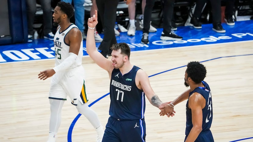 Dallas Mavericks guard Luka Doncic (77) celebrates with guard Spencer Dinwiddie (26) after a...